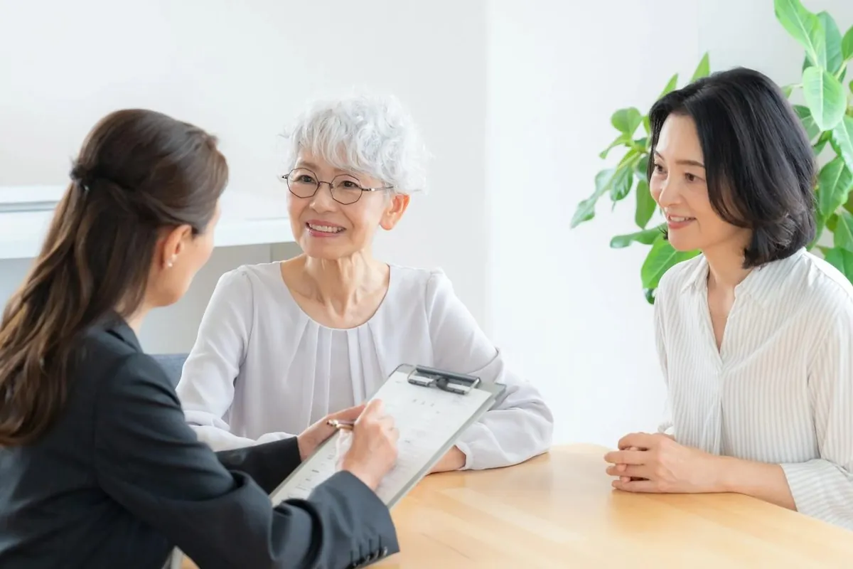 女性スタッフと相談する年配の女性と娘